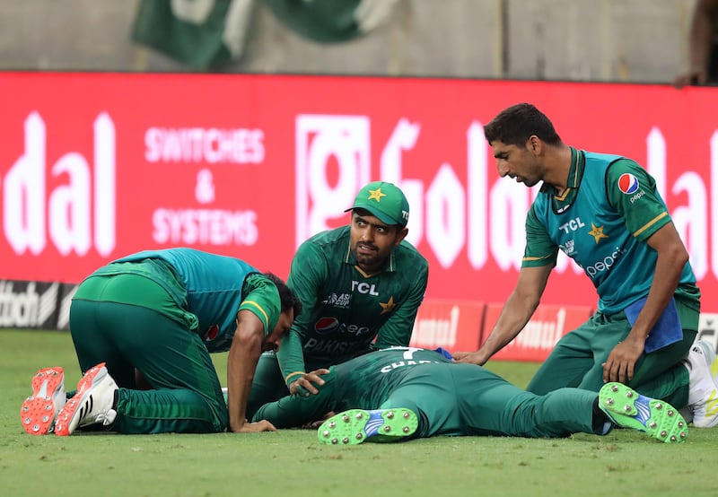 Pakistan's Shadab Khan lies injured after attempting a catch.