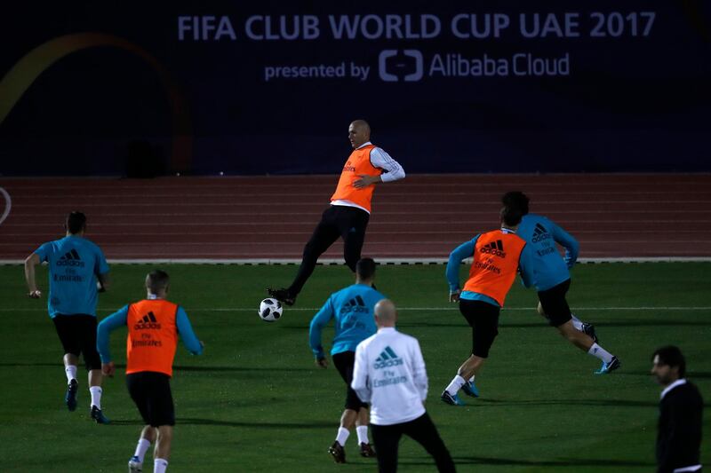 Real Madrid's head coach Zinedine Zidane controls the ball as he trains. Hassan Ammar / AP Photo