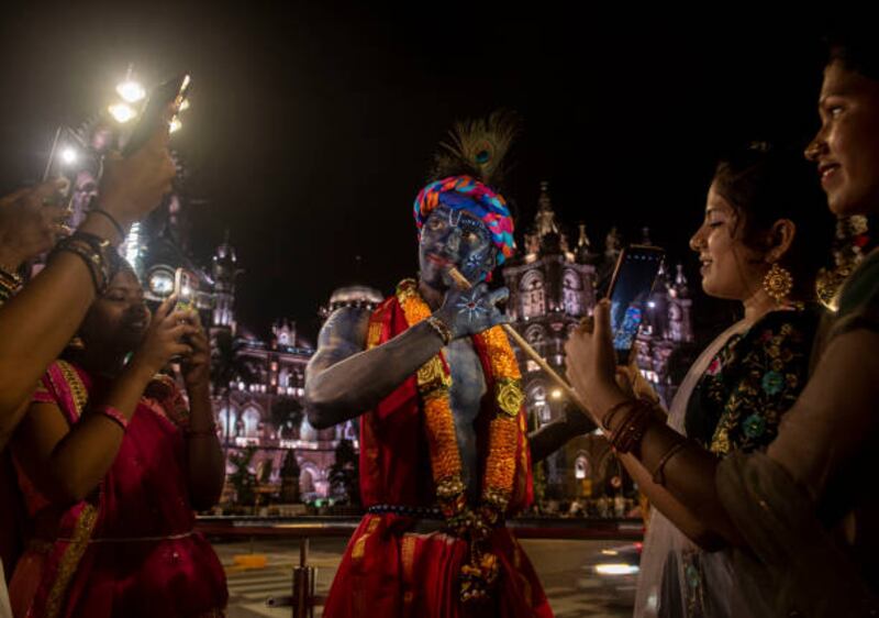 Fun at the festival for a boy dressed as Lord Krishna  in Mumbai. Getty Images