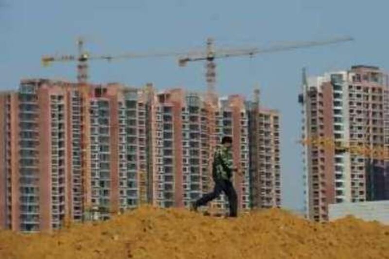 A worker walks near buildings under construction in Hefei, Anhui province, October 23, 2008. China's Ministry of Finance on Wednesday announced a series of policy changes that will make it easier for people to buy their first homes, fleshing out a directive approved last week by the cabinet. REUTERS/Stringer (CHINA).  CHINA OUT. NO COMMERCIAL OR EDITORIAL SALES IN CHINA. *** Local Caption ***  PEK05_CHINA-ECONOMY_1023_11.JPG