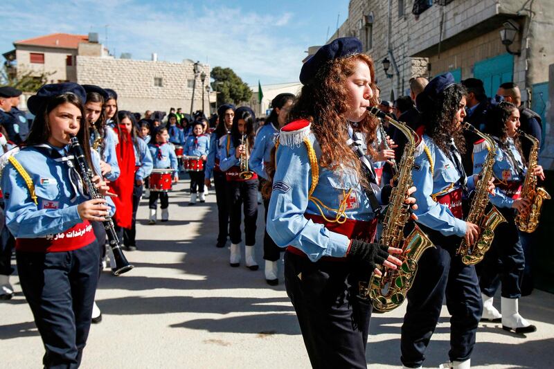 Palestinian scout troops perform during a parade ahead of the arrival of the Relic of the Holy Crib of the Child Jesus at the Church of the Nativity compound in Bethlehem.  AFP