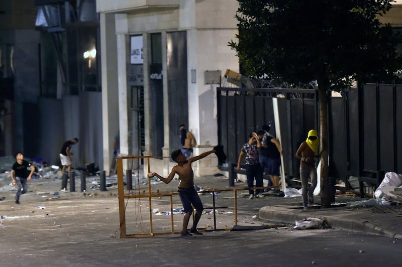 Anti-government protesters hurl stones at Lebanese riot police during a protest against the Lebanese politicians who have ruled the country for decades, outside of the Lebanese Parliament in downtown Beirut, Lebanon. EPA