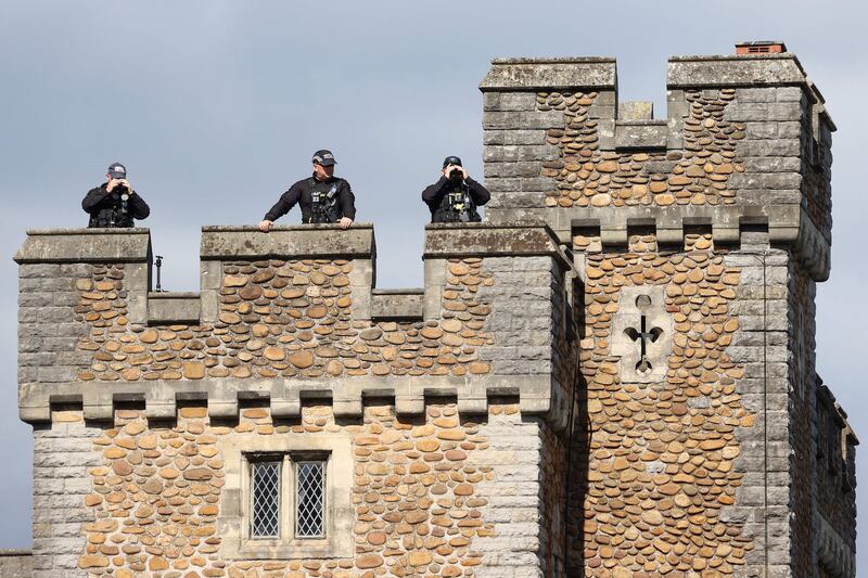 Police officers stand guard on top of Cardiff Castle. AFP