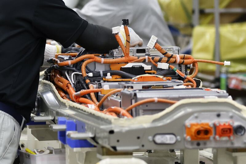 A worker assembles a battery pack for a kei electric vehicle on the production line at the Mitsubishi Mizushima plant in Kurashiki, Okayama Prefecture. Bloomberg
