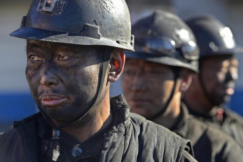 Miners wait in lines to shower during a break near a coal mine in Heshun county, Shanxi province on December 5, 2014. Chinese coal spot prices are being raised in a domestic market struggling to recover from seven-year lows, desperate for an edge in annual negotiations to supply power plants, key buyers in the world's biggest consumer of coal, industry sources say. Reuters