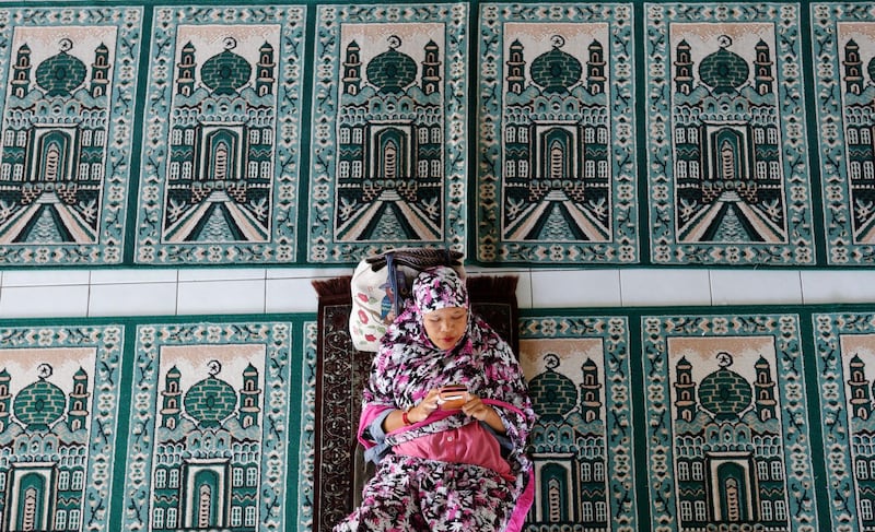 A woman rests at a mosque during the first day of the holy fasting month of Ramadan Monday in Bali, Indonesia. Muslims around the world marked the start of Ramadan on Monday, a month of intense prayer, dawn-to-dusk fasting and nightly feasts. AP Photo