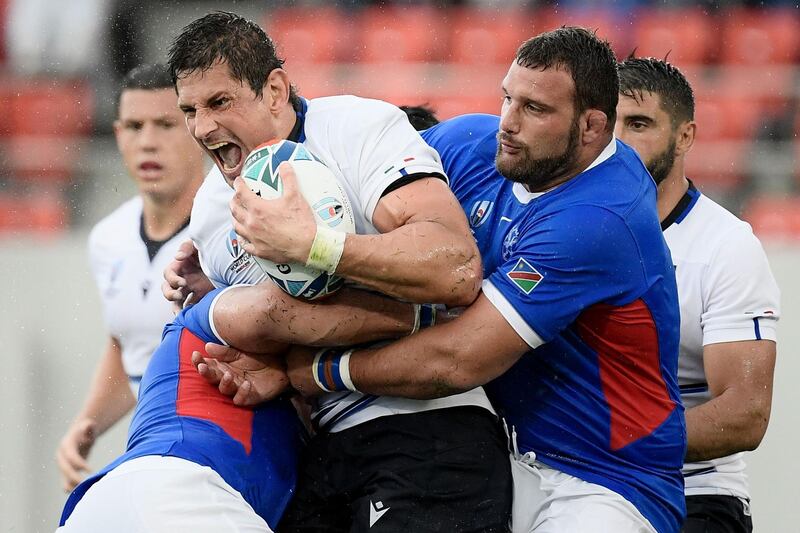 Italy lock Alessandro Zanni, centre, is tackled by Namibia players. AFP