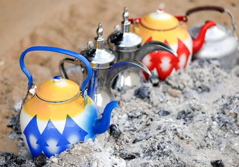 Abu Dhabi, United Arab Emirates, December 10, 2019.  
  Al Dhafra Festival 2019.
--  Tea pots heating up on charcoal in a tent.
Victor Besa/The National
Section:  NA
Reporter:  Anna Zacharias