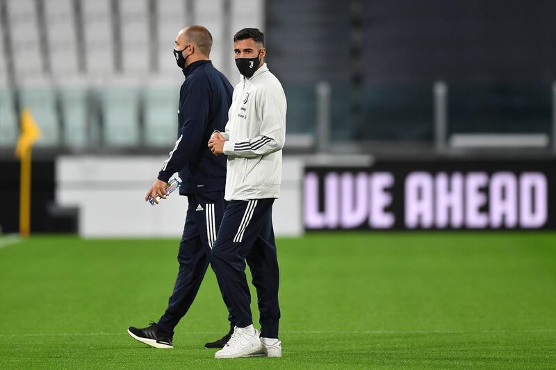 Juventus player Gianluca Frabotta and assistant coach Igor Tudor walk out onto the pitch ahead of the game. Getty Images