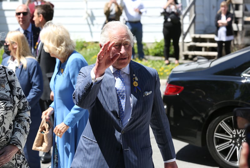 Britain's Prince Charles and Camilla, Duchess of Cornwall waves during a visit at Assumption Catholic school May 18, 2022 in Ottawa. AFP