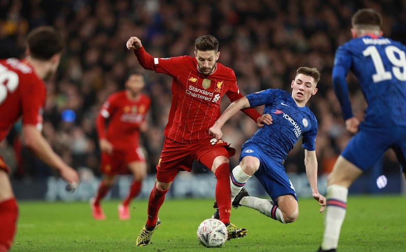 Billy Gilmour dives into a challenge against Adam Lallana. AP Photo