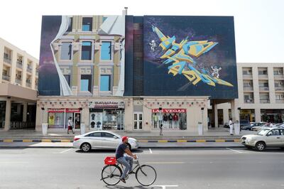 DUBAI , UNITED ARAB EMIRATES, September 20 , 2018 :- Artwork painted by different artists on the wall of Wasl Properties at the Karama shopping complex in Al Karama area in Dubai. ( Pawan Singh / The National )  For Big Picture/Online/Instagram