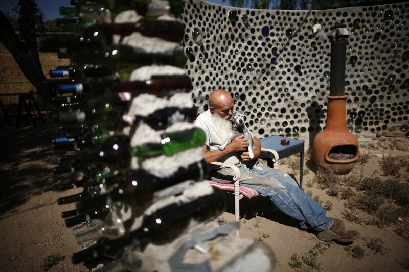 Artist Roy Lohr sits in a “spaceship” he built in his backyard from wine and beer bottles in Truth or Consequences, New Mexico. Lucy Nicholson / Reuters