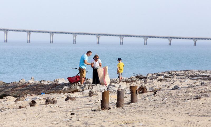 US citizens in Kuwait take part in a cleanup campaign at Asheraj beach. AFP
