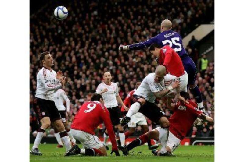 Pepe Reina, right, the Liverpool goalkeeper, punches the ball away during their 1-0 FA Cup third-round defeat to Manchester United on Sunday. Alex Livesey / Getty Images