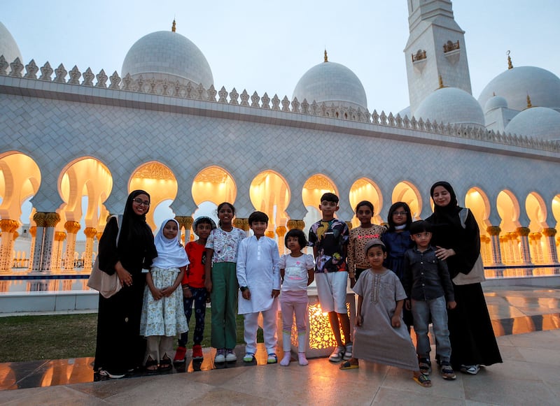 Worshippers pose for a photo before iftar at the Sheikh Zayed Grand Mosque in Abu Dhabi. Victor Besa / The National