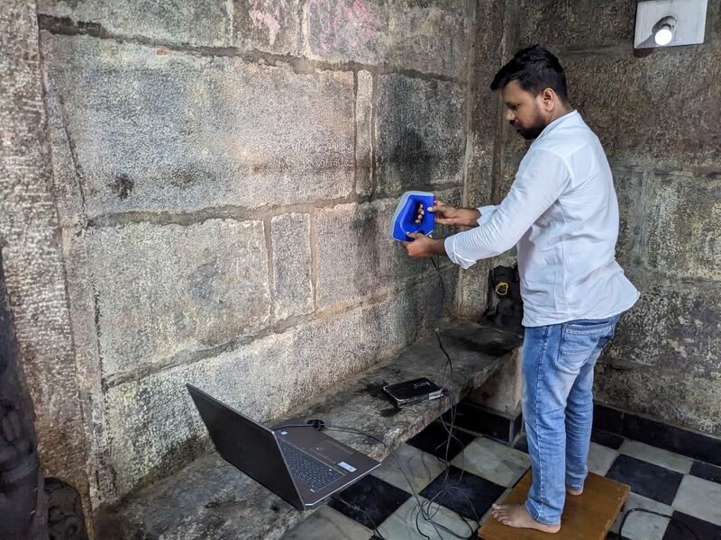 A team member 3D-scans a 10th-century inscription on the wall of a temple at Kudlur Channapatna. Photo: PL Udaya Kumar