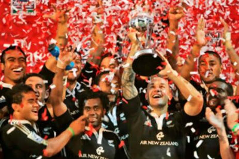 New Zealand's Rugby team captain, DJ Forbes, second from right, celebrates with fellow team members as he holds the trophy after they beat Fiji 31-21 in their final match of Rugby Sevens in Dubai, Saturday, Dec. 1, 2007. (AP Photo/Kamran Jebreili)