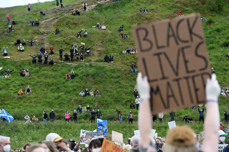 A protester holds a placard at a demonstration in Edinburgh.  AFP