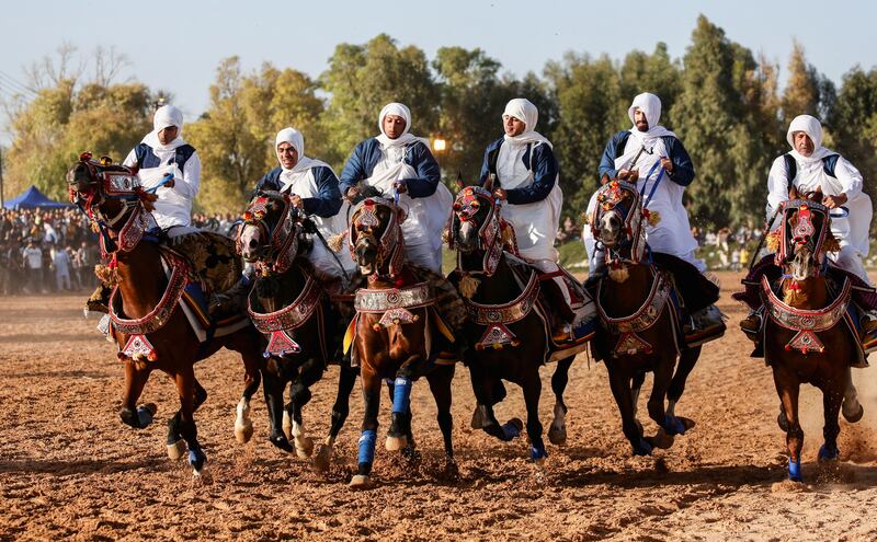 Men wearing traditional dress compete in a horse race in Misurata, Libya. Reuters