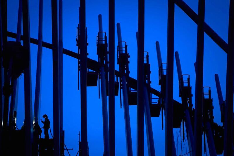 A welder works on part of the World Trade Center after sunset in New York October 24, 2014.  Carlo Allegri / Reuters