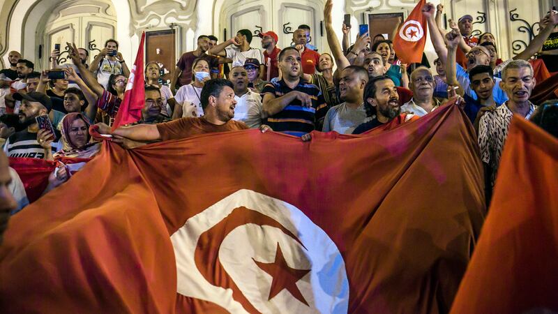 People celebrate in Tunis after the exit polls indicate that voters approved Tunisia's new constitution in a referendum held on July 25, 2022.  AP Photo