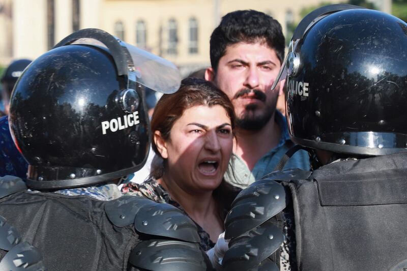 An Iraqi kurdish woman confronts riot police as she takes part in a demonstration to denounce the Turkish assault in northern Iraq. AFP