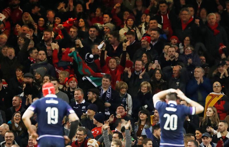 Rugby Union -  Six Nations Championship - Wales vs Scotland - Principality Stadium, Cardiff, Britain - February 3, 2018   Wales fans celebrate a try as Scotland's Grant Gilchrist (L) and Ryan Wilson look dejected   Action Images via Reuters/Andrew Boyers