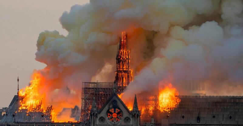 Smoke billows as flames burn through the roof of the Notre-Dame Cathedral on April 15, 2019. AFP Photo