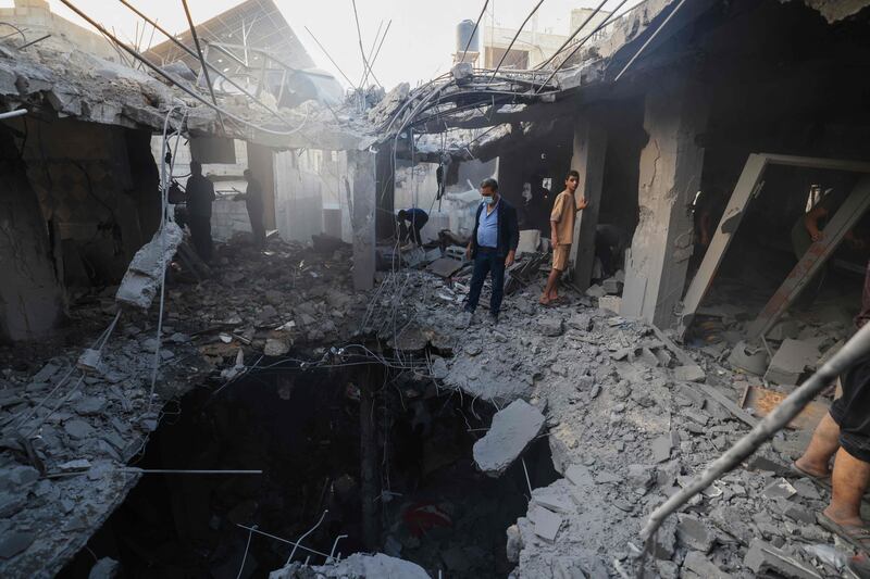 Palestinians search for survivors in the rubble of a building following Israeli bombardment in Khan Yunis. AFP