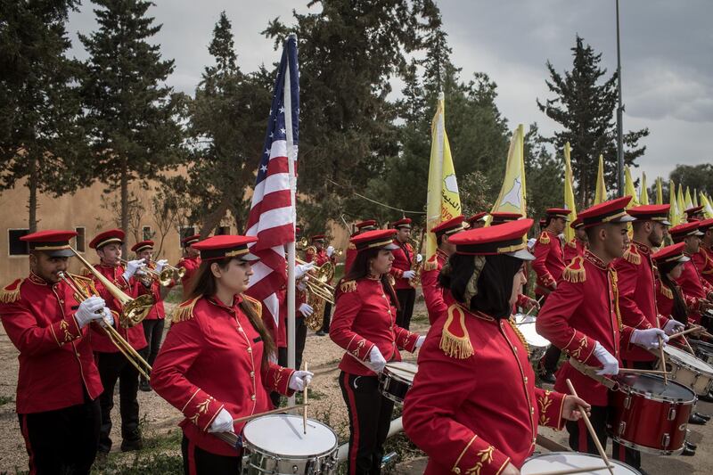 DEIR AL ZOR, SYRIA - MARCH 23: Members of the Syrian Democratic Forces (SDF) band play the American anthem during a SDF victory ceremony announcing the defeat of ISIL in Baghouz held at Omer Oil Field on March 23, 2019 in Deir Al Zor, Syria. The Kurdish-led and American-backed Syrian Defense Forces (SDF) declared on Saturday the "100% territorial defeat" of the so-called Islamic State, also known as ISIS or ISIL. The group once controlled vast areas across Syria and Iraq and a population of up to 12 million, an aspired "caliphate" that drew tens of thousands of foreign nationals to join its ranks. (Photo by Chris McGrath/Getty Images)