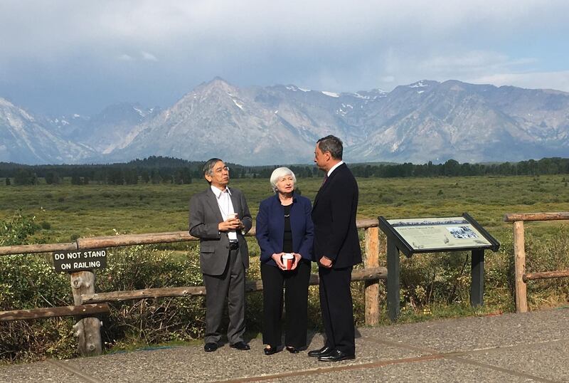 Federal Reserve Chair Janet Yellen, talks with Mario Draghi, head of the European Central Bank, and Haruhiko Kuroda, head of the Bank of Japan, during a break at the central bankers conference at Jackson Hole, Wyo., Friday, Aug. 25, 2017. The conference, in its 41st year, is sponsored by the Federal Reserve Bank of Kansas City.  (AP Photo/Martin Crutsinger)