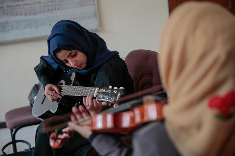 A female Yemeni music student practices playing the guitar during a music class at the Cultural Centre in Sanaa, Yemen. Hani Mohammed / AP Photo