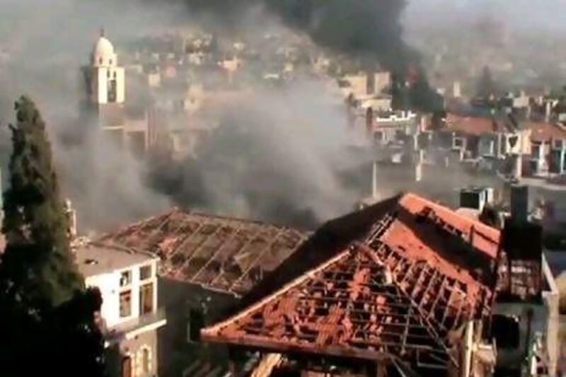 An image grab taken from a video uploaded on YouTube on June 11, 2012 shows smoke billowing from the flashpoint Syrian city of Homs.