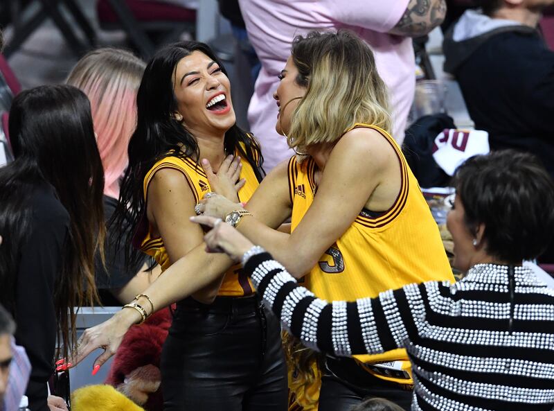 Kourtney Kardashian, in a basketball jersey and leather trousers, with sister Khloe Kardashian at the 2017 NBA Finals on June 9, 2017. Getty Images