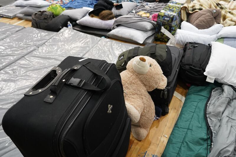 Ukrainians are sleeping beside luggage in Tijuana.