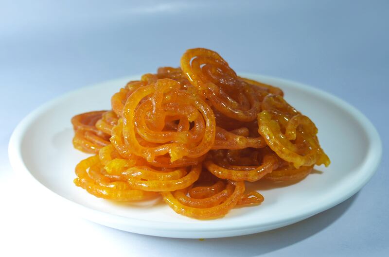 Jalebi, a vivid orange circular sweet made from deep-fried maida flour doused in sugar syrup.