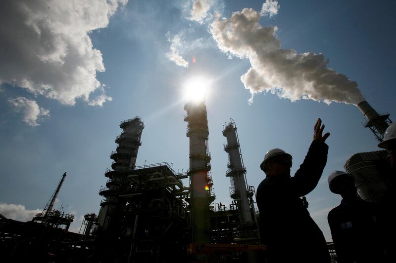 FILE PHOTO:    James Prokupek (L), an engineering department process design manager for the Valero St. Charles Oil Refiner, is seen in silhouette during a tour of the refinery in Norco, Louisiana, August 15, 2008.    To match Special Report USA-BIOFUELS/VALERO    REUTERS/Shannon Stapleton/File Photo