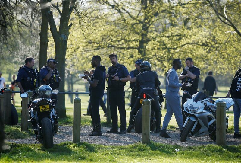 The police talk to people in Clapham Common, London, UK on April 5, 2020. Reuters