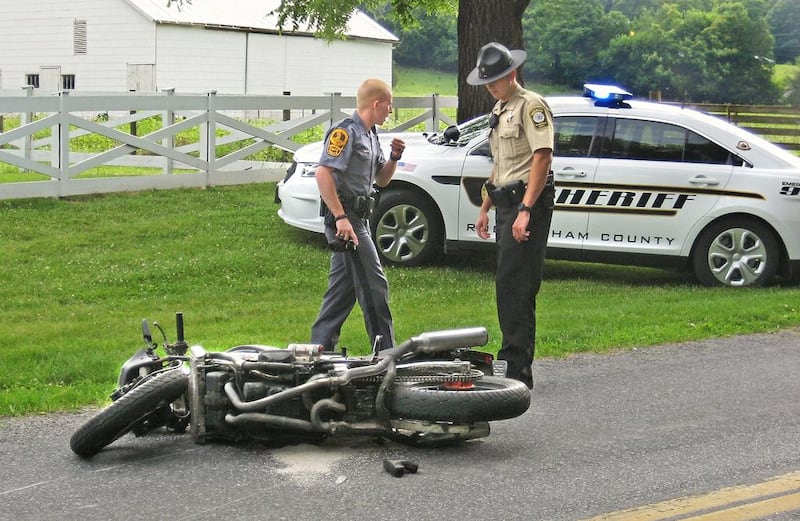 A Virginia State trooper and a Rockingham County sheriff's deputy investigate the scene of a motorcycle/pickup truck collision in eastern Rockingham County. The advent of driverless cars will make motocycling much safer which will in turn boost motobike sales.Bryan Gilkerson / AP