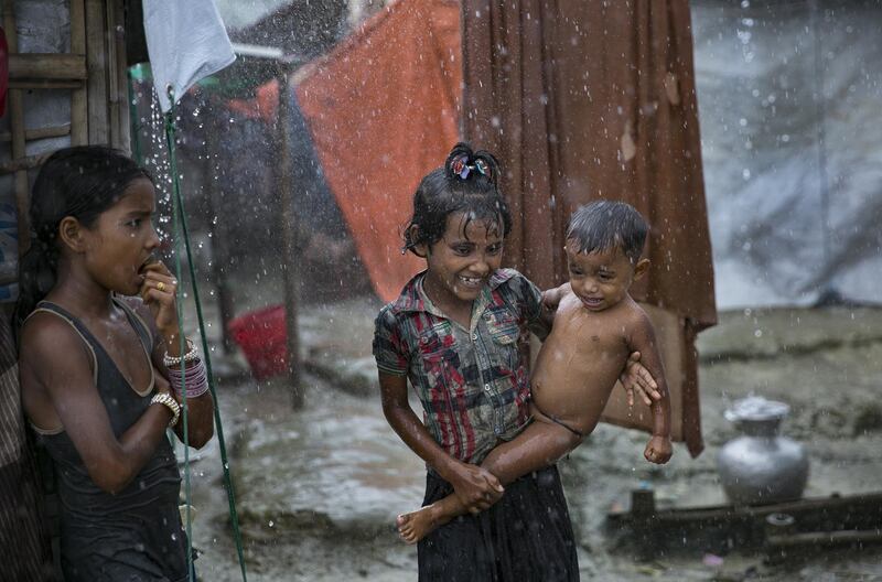 Children are seen enjoying the rain at the Nayapara refugee camp in Cox's Bazar, Bangladesh. Getty Images