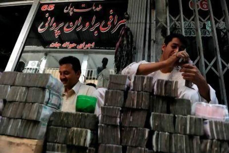 Money changers count bundles of bank notes in Kabul last year.