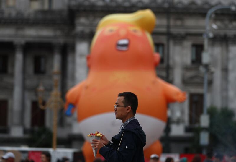 The 'Baby Trump' balloon was first seen in the skies above London, travelled to France and is now on display in the streets of Buenos Aires. Reuters