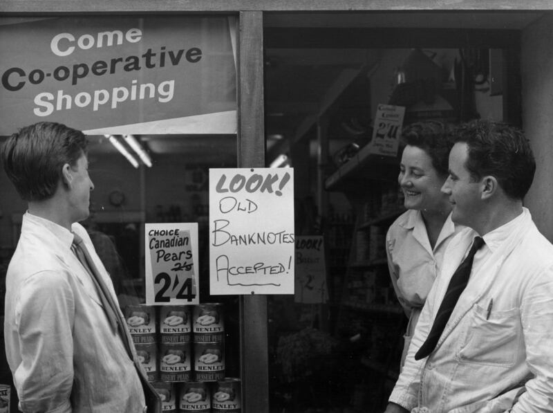 A manager and two assistants outside a Co-Op in 1963