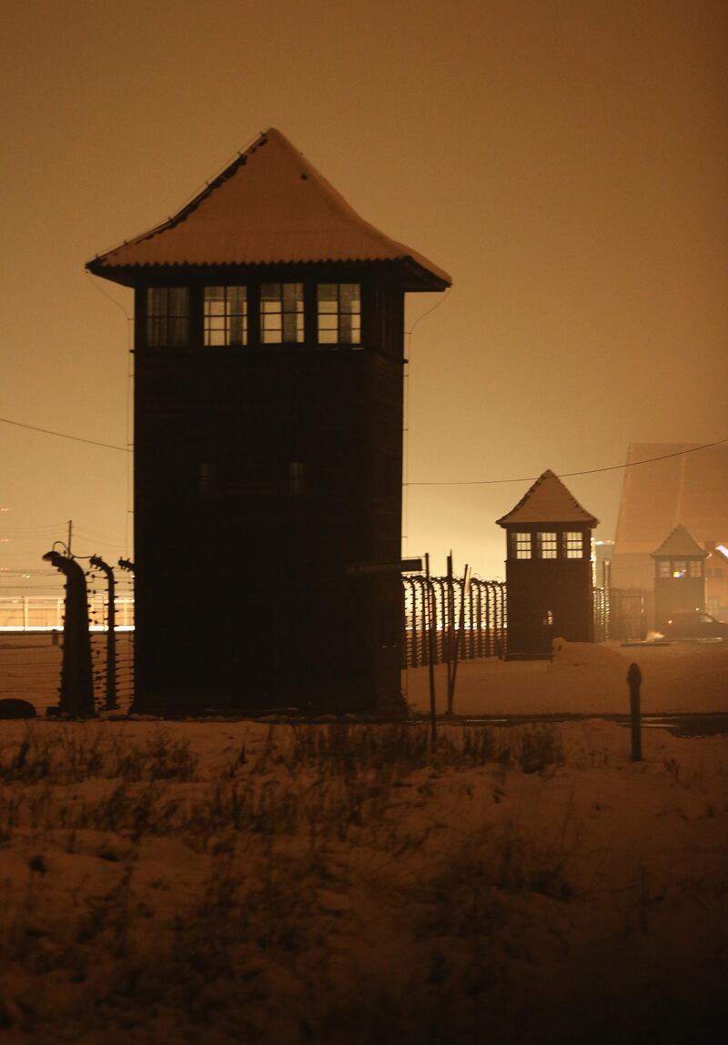 OSWIECIM, POLAND - JANUARY 26:  Guard towers and barbed wire fences stand at the former Auschwitz-Birkenau concentration camp on the night prior to commemoration events marking the 70th anniversary of the liberation of the camp on January 26, 2015 in Oswiecim, Poland. International heads of state, dignitaries and over 300 Auschwitz survivors will commemorate the 70th anniversary of the liberation of Auschwitz by Soviet troops in 1945 on January 27. Auschwitz was among the most notorious of the concentration camps run by the Nazis to enslave and kill millions of Jews, political opponents, prisoners of war, homosexuals and Roma.  (Photo by Sean Gallup/Getty Images)