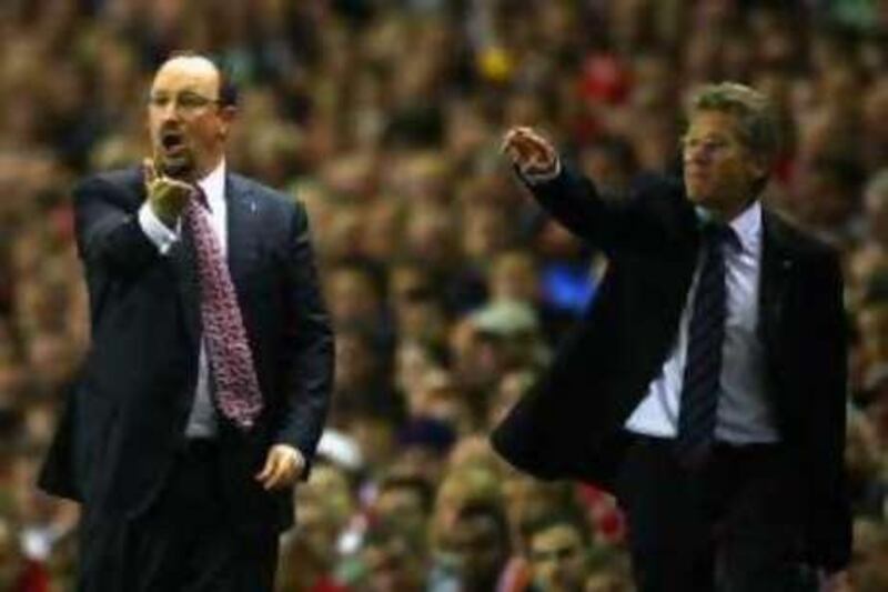 LIVERPOOL, UNITED KINGDOM - AUGUST 27:  Rafael Benitez of Liverpool gestures to his players in front of Laszlo Boloni of Standerd Liege during the UEFA Champions League Qualifier Third Round second Leg Match between Liverpool and Standard Liege at Anfield on August 27, 2008 in Liverpool, England.  (Photo by Laurence Griffiths/Getty Images)