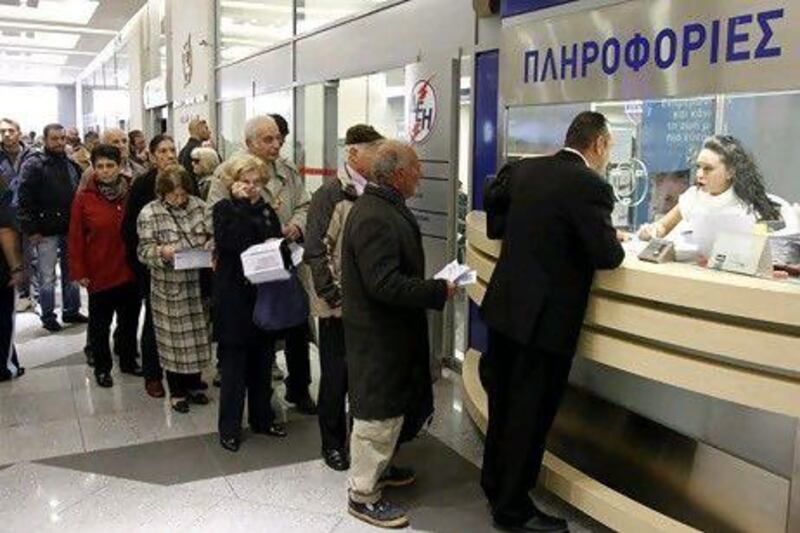 Greeks queue up at a DEH (Public Power Company) office in Athens to ask about the new property tax, which will be included in future energy bills. The Greek prime minister said that his debt-strapped country will hold a referendum on the new European debt deal reached last week. Thanassis Stavrakis / AP Photo