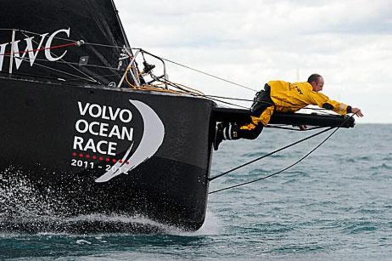 Ian Walker, the Abu Dhabi Ocean Racing skipper, works on the lines at the bow as Azzam sets sail from Alicante to Cape Town.