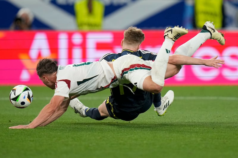 Scotland's Stuart Armstrong is brought down in the box by Hungary's Willi Orban but the defender went unpunished. AP 