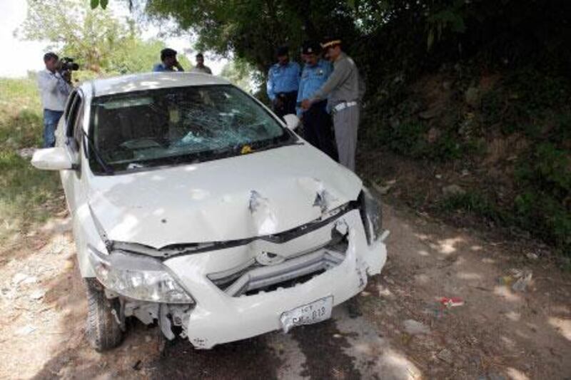 Pakistan police inspect the car which Chaudhry Zulfiqar was driving when he was shot dead by gunmen in Islamabad today,